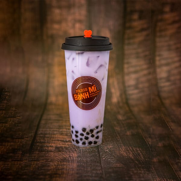Paris Banh Mi Cary taro bubble tea with tapioca pearls and a heart-shaped stopper.