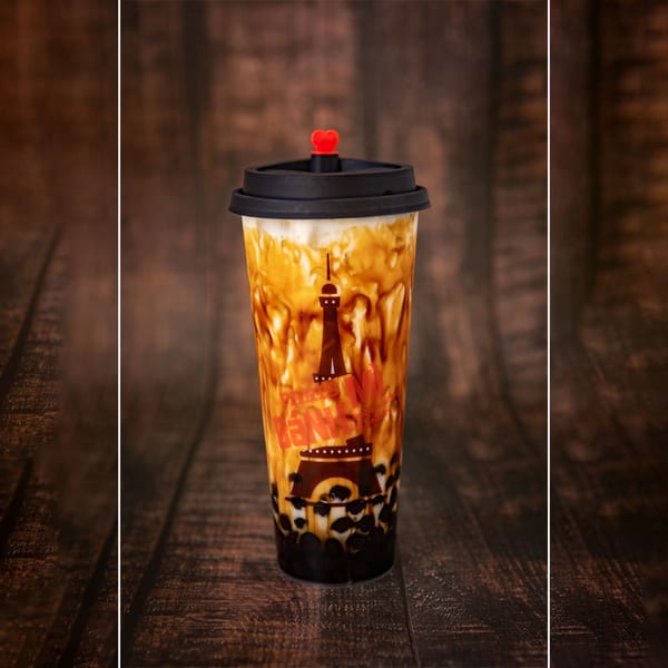 Paris Banh Mi Cary's brown sugar boba tea with a black lid and red heart stopper.